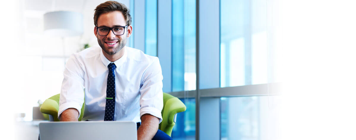 handsome man smiling at you in work enviroment